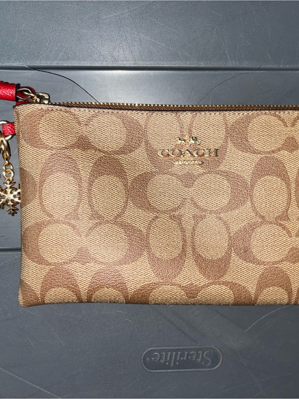 Coach Tan Signature Canvas Wristlet with Red Strap Accent